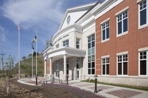 dramatic radiused stone entry that creates a one-story canopy with limestone columns