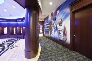 The center court graphics and a “NCAA Champion 2012” banner are the focus of the newly renovated circular, wood paneled locker room