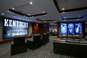 Joe Craft Center - Marksbury Player's First Men's Basketball Locker Room players lounge with custom millwork and wall graphics, an interactive video monitor allowing access to individual player statistics, and a contiguous multi-screen video wall for game playback, and player entertainment and gaming.